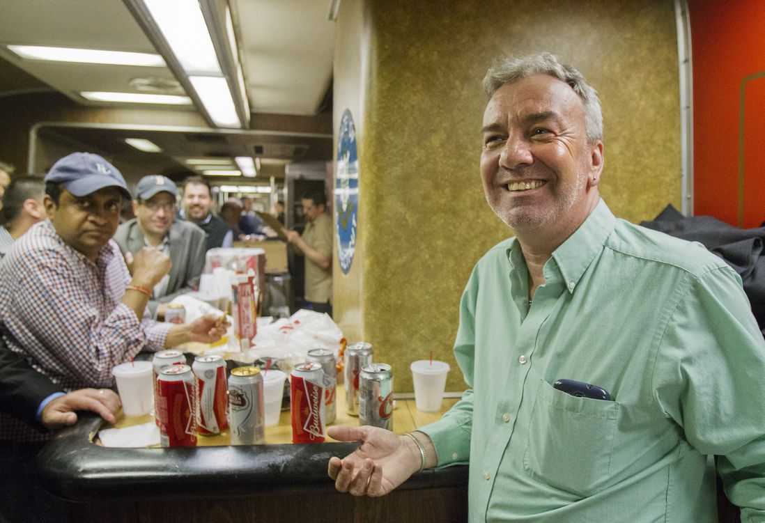 Mark DeMonte, right, of Wallingford, Conn., join other riders in the bar car on the 7:07 p.m. train to New Haven, Conn., at Grand Central Terminal on Thursday, May 8, 2014 in New York. DeMonte, a bar car regular, has been dubbed "Mayor of the 5:48" by friends and riders of his usual train.